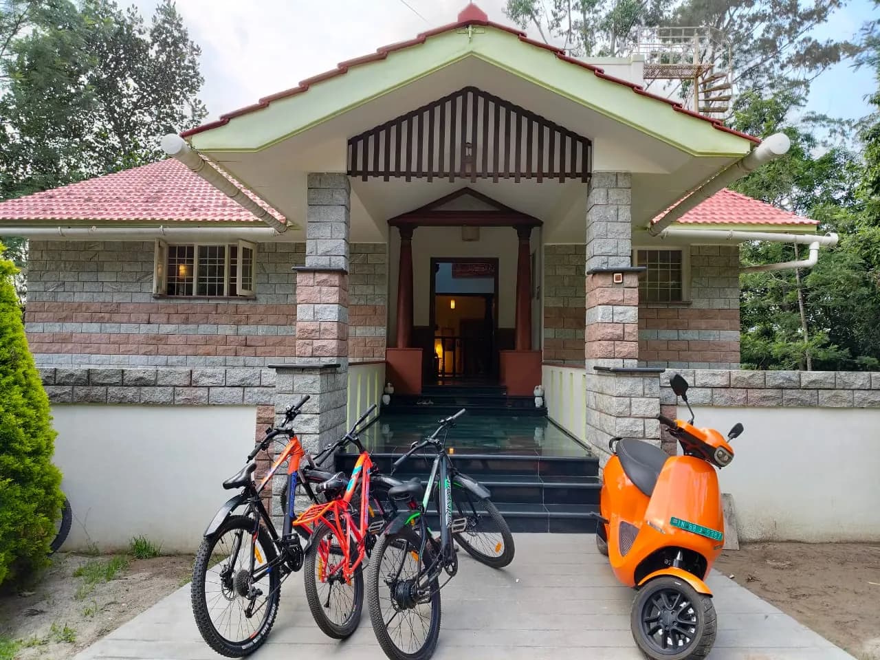 Bungalow entrance with bicycles and electric scooter
