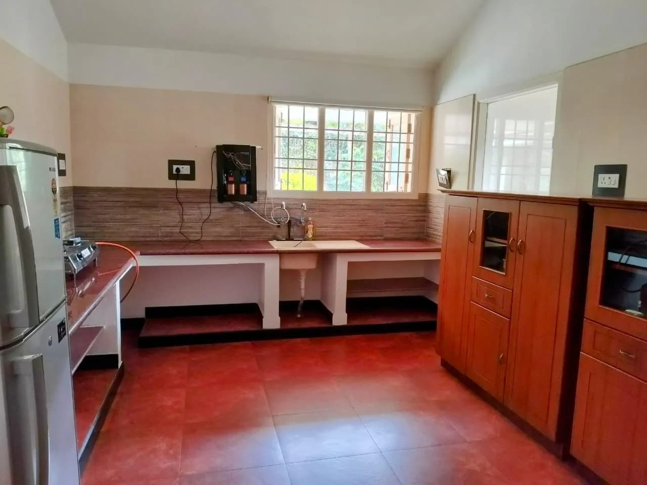 Kitchen with counters, storage and fridge