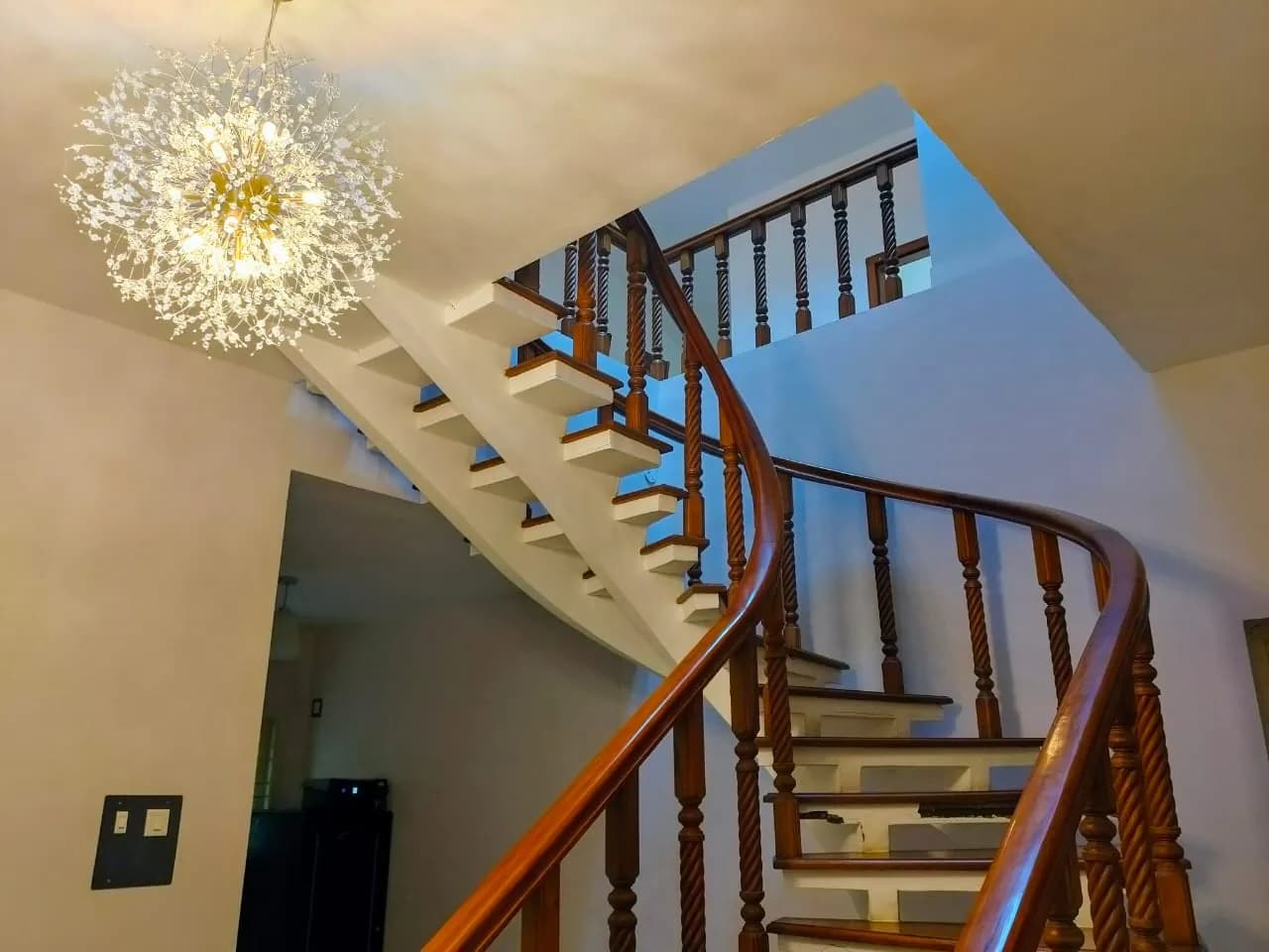 Wooden staircase beneath the chandelier